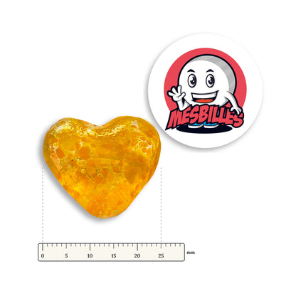 Bille Coeur Cristal Mouchetée Orange à côté d'une règle graduée, environ 25 mm de large