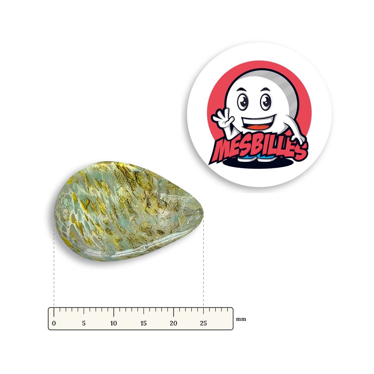 Bille Oeuf Cristal Moucheté Jaune couchée à côté d'une règle graduée, environ 25 mm de long